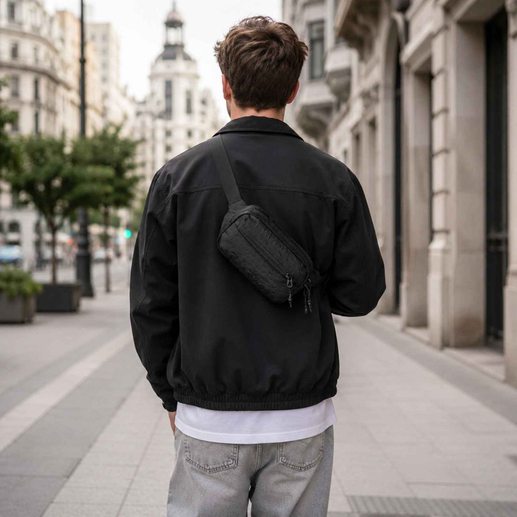 Hombre usando bandolera compacta RFID KÄRN negra, alternativa ligera para llevar lo esencial sin mochila